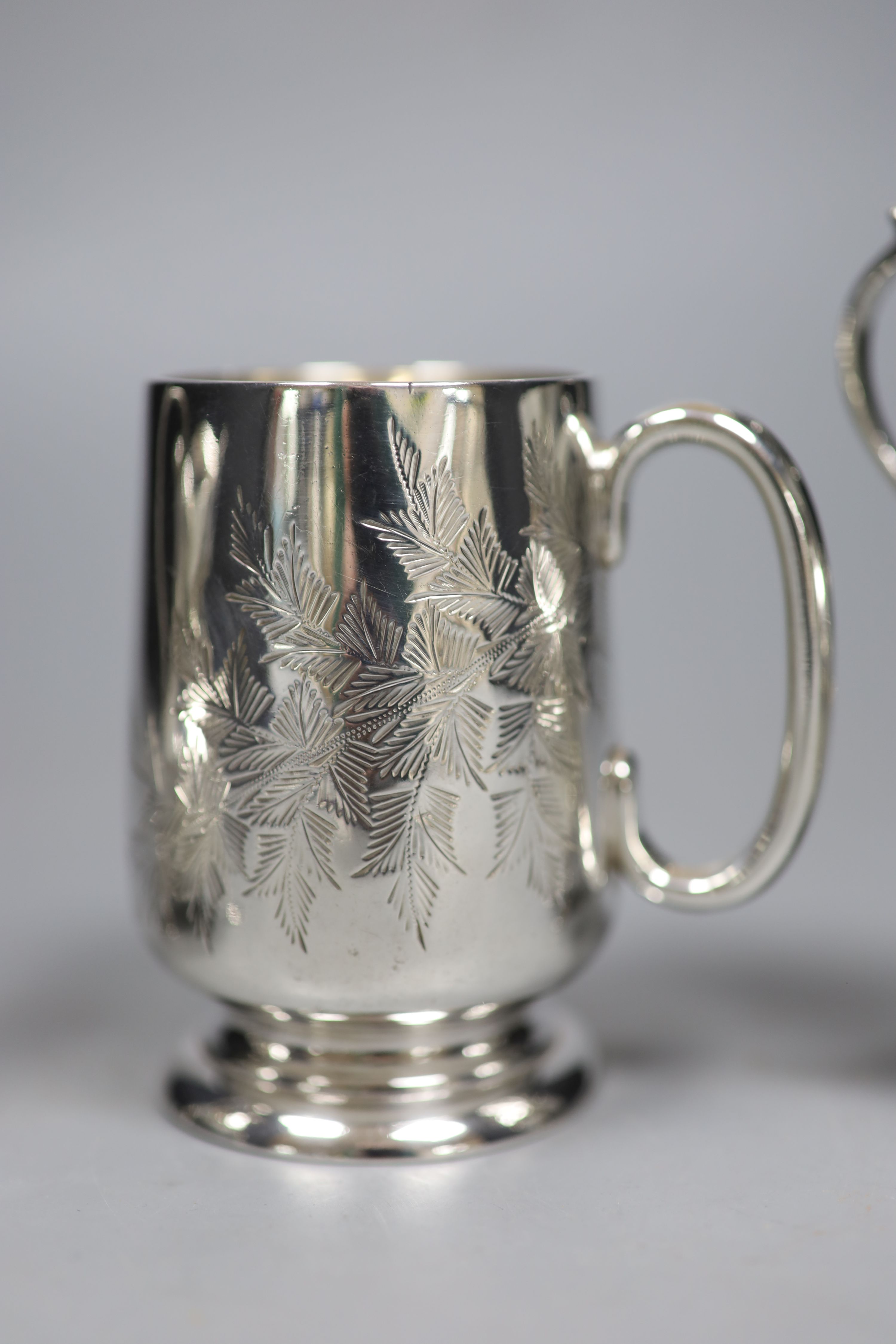 A Victorian engraved silver footed Christening mug and four silver cream jugs, various, 12.3 oz approx